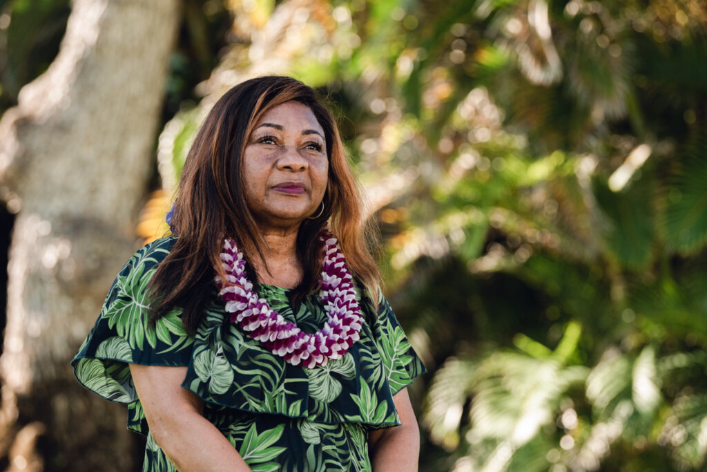 Catherine Coleman Flowers wears a lei and smiles warmly in a headshot