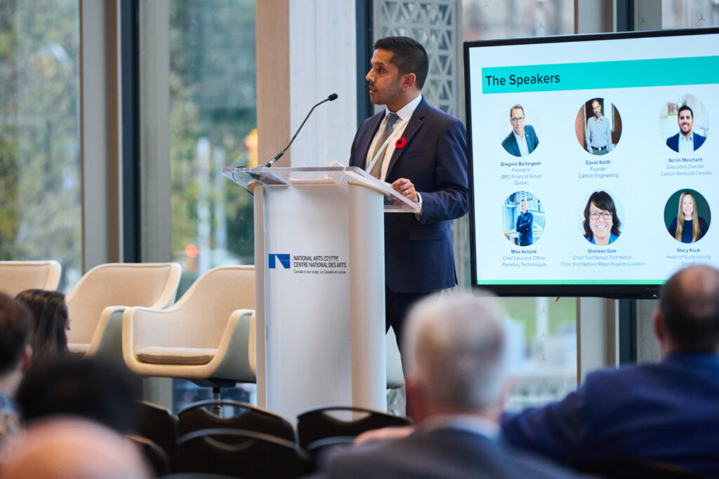 Na'im Merchant stands at a podium to address the crowd during the Carbon Removal Canada launch event.