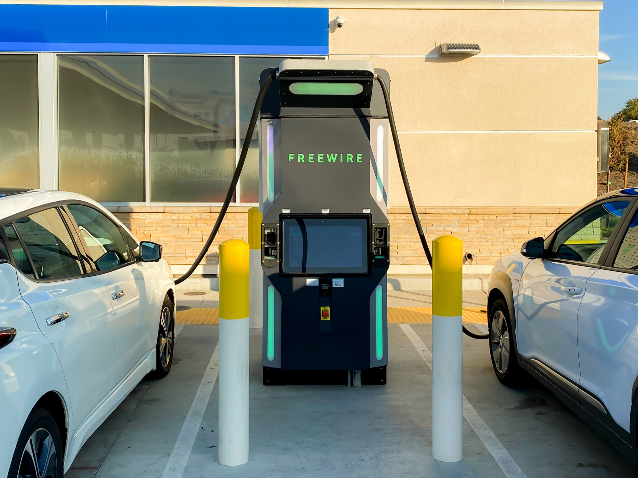 Two cars plugged into FreeWire Boost EV Charger.